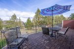 Juniper Haven Getaway has a roomy back patio area with seating for 6, a dining area for outdoor meals, and views of scenic Central Oregon.